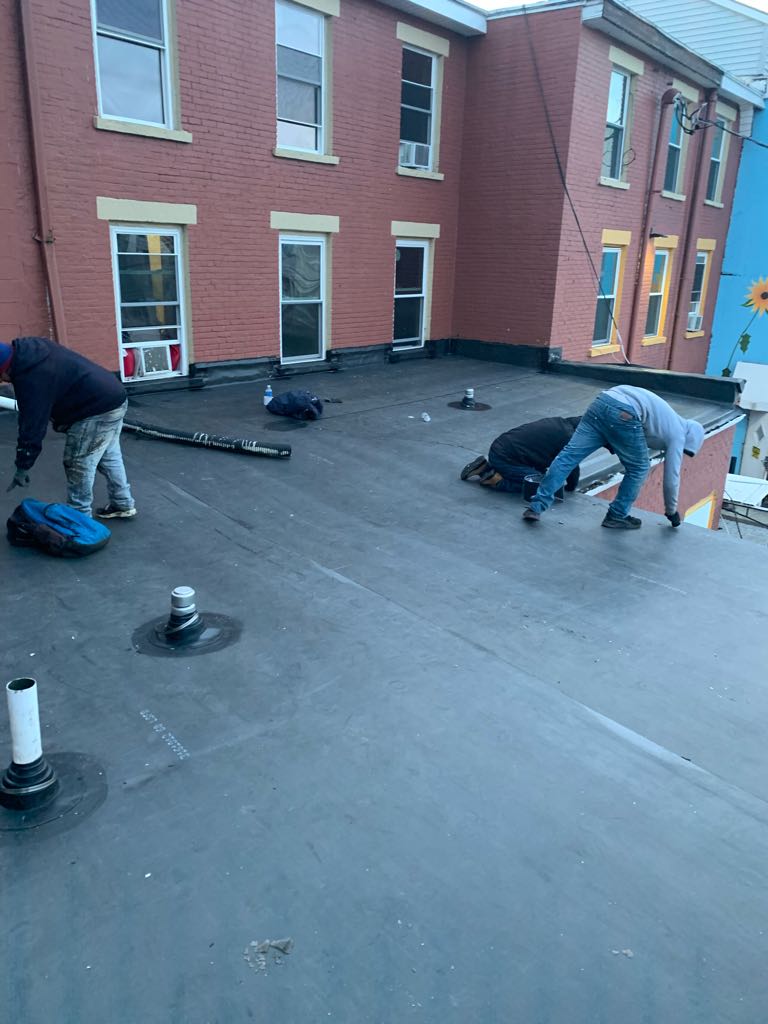 Flat roof installation crew at work