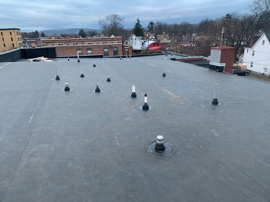 Completed flat roof with multiple vent penetrations