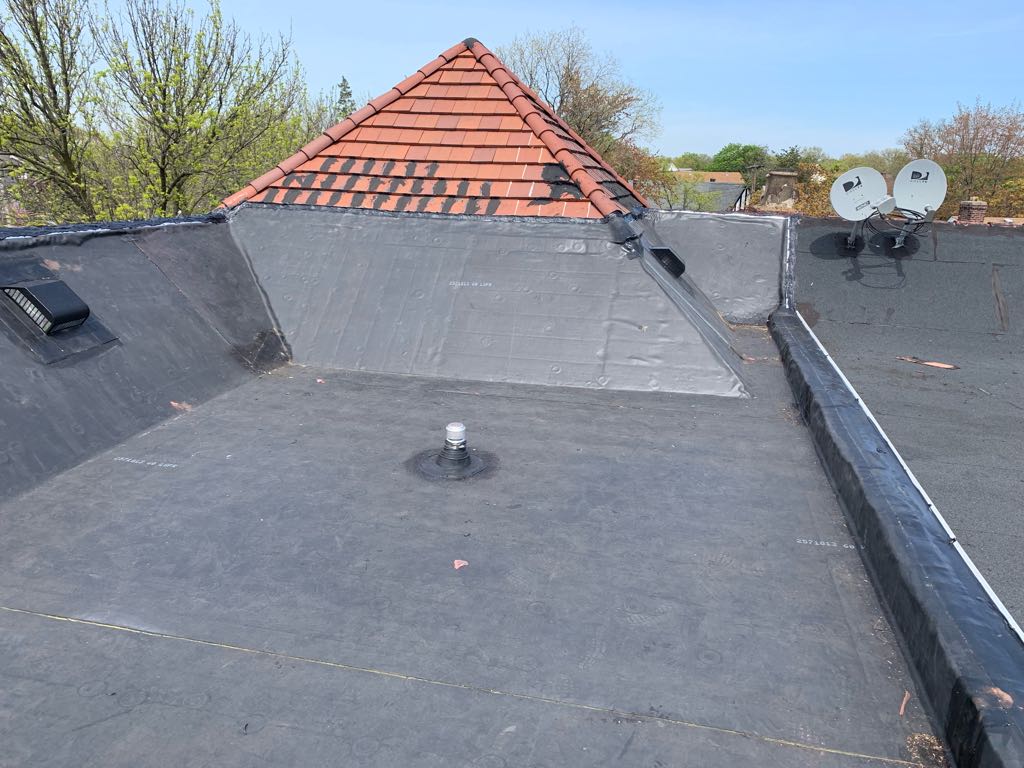 EPDM flat roof meeting clay tile turret